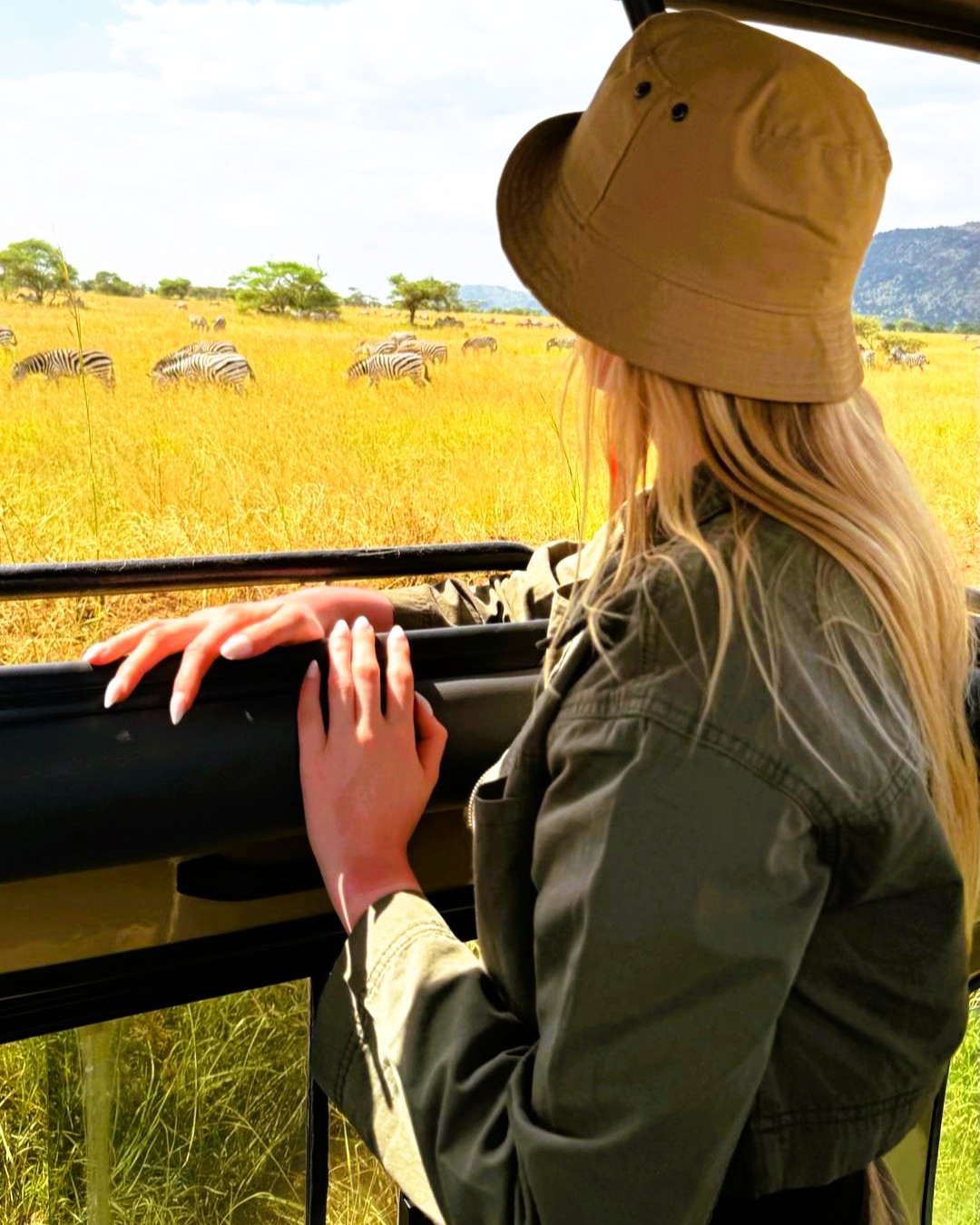 Ngorongoro Crater rim view with safari vehicles descending